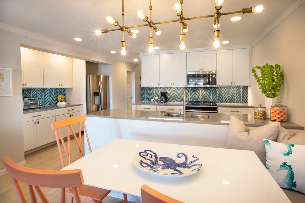 A modern kitchen and dining room with great lighting