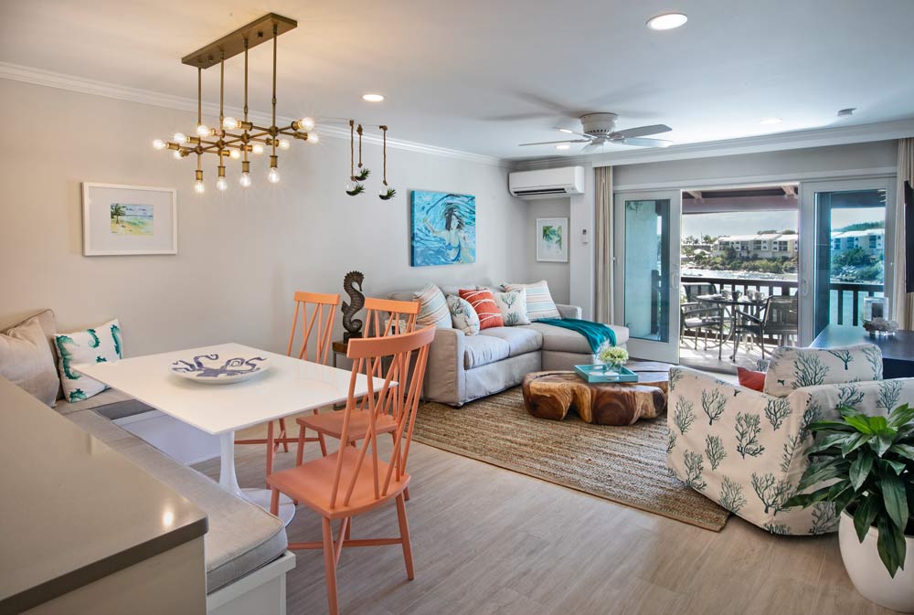 A living and dining room that uses conservative colors indoors allows the accentuates the colors from the view outside.