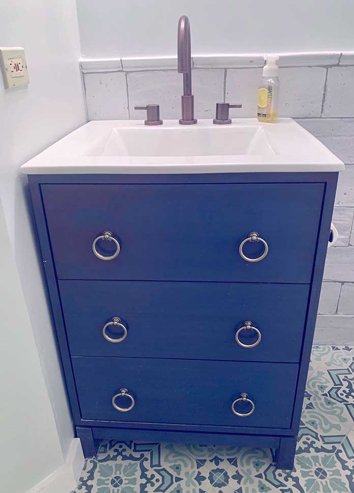 The finished bathroom vanity hand painted with a matte cobalt blue color.