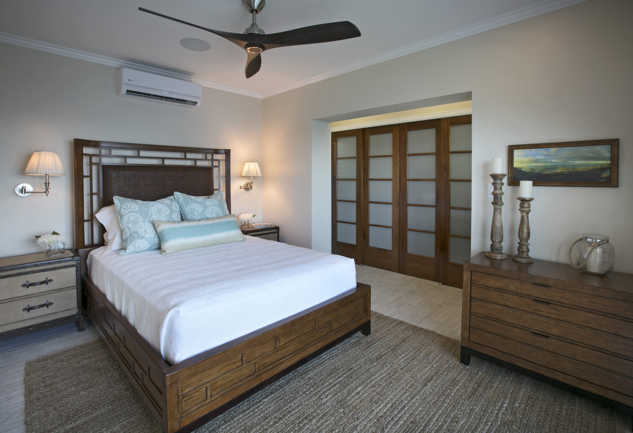 Fresh white bedding basics and natural textures in this guest room make it feel clean and inviting