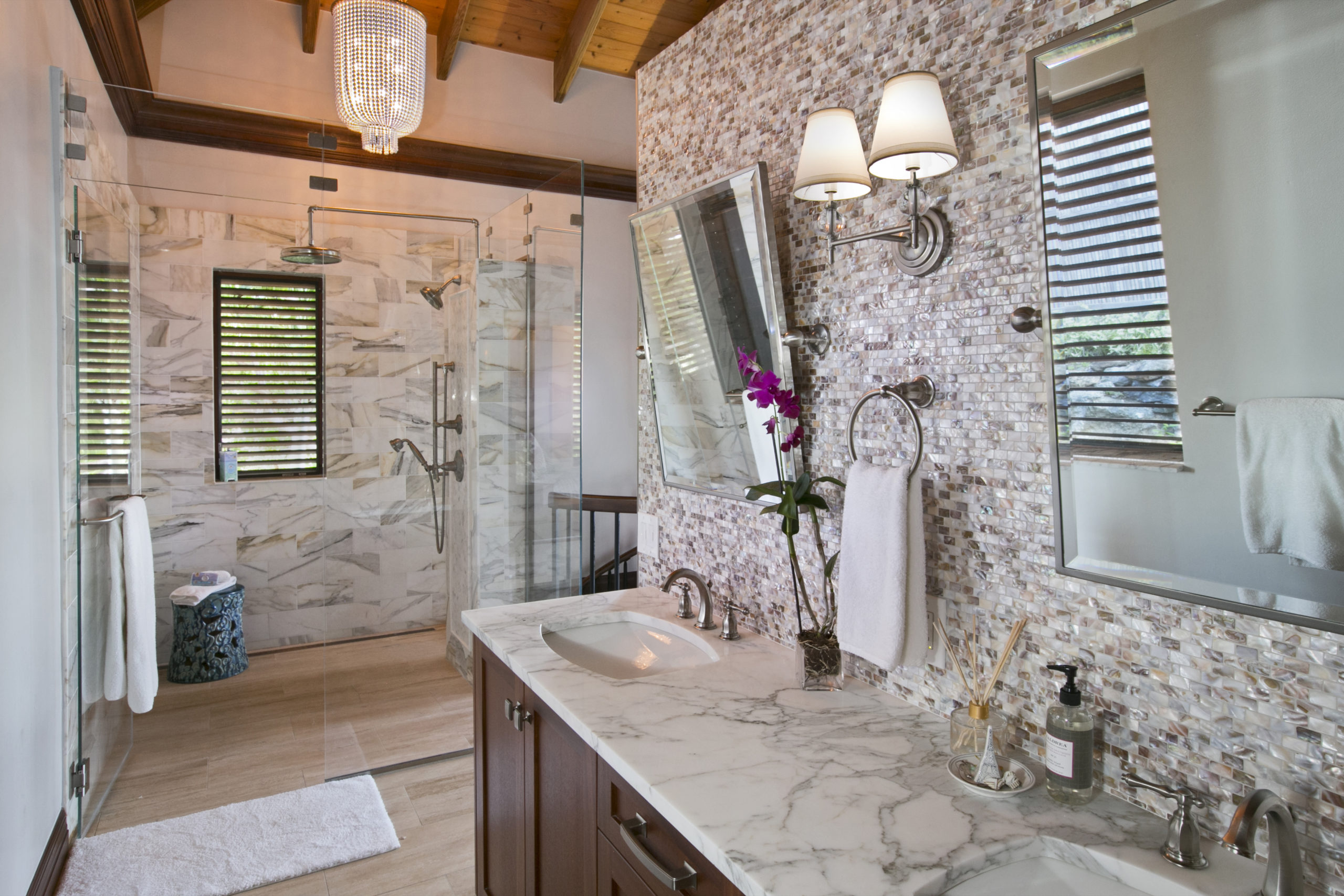 Master bathroom with calacatta tile a double vanity and luxurious walk in shower.