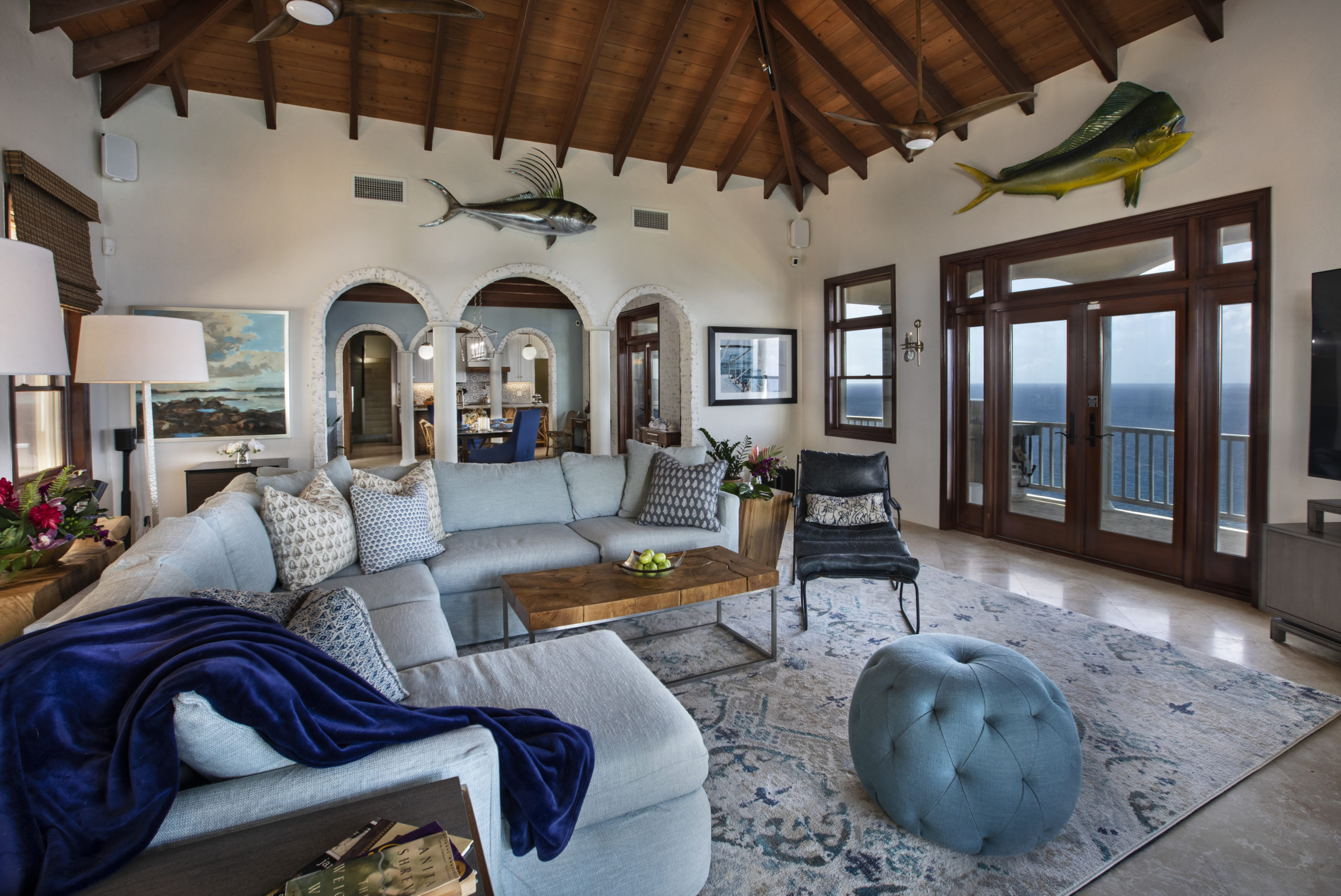 Caribbean living room with a U shaped sofa (section with chaise) and leather Cisco chair. All furnishings are pet friendly. Living room with caribbean ocean view.