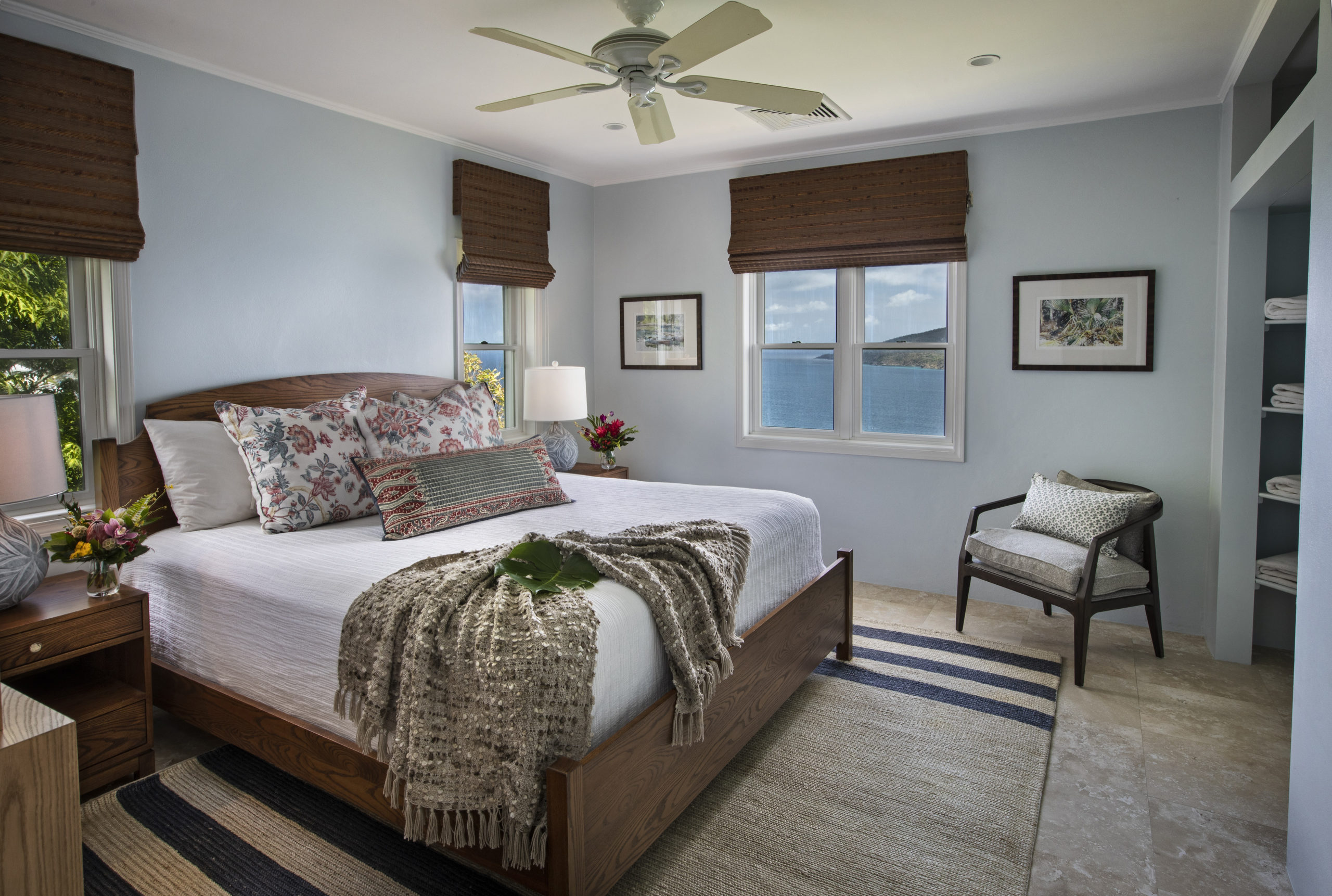 Guest room with a mahogany bed and annie selkie easy care bedding. Bamboo blinds from Horizon. Bedroom has ocean views and views of Hans Lollick
