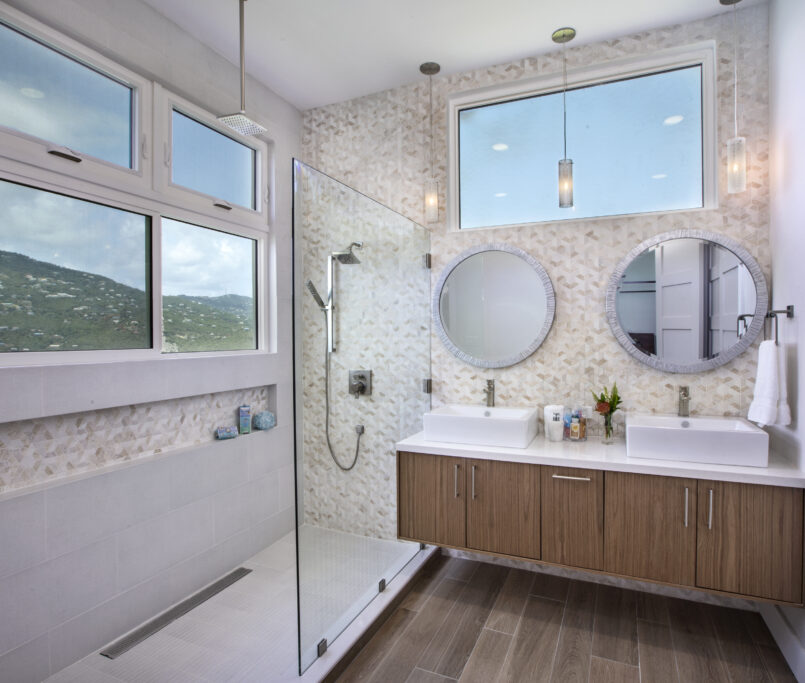 Double Vanity Bath with Waterfall show head and floating cabinetry with gorgeous views