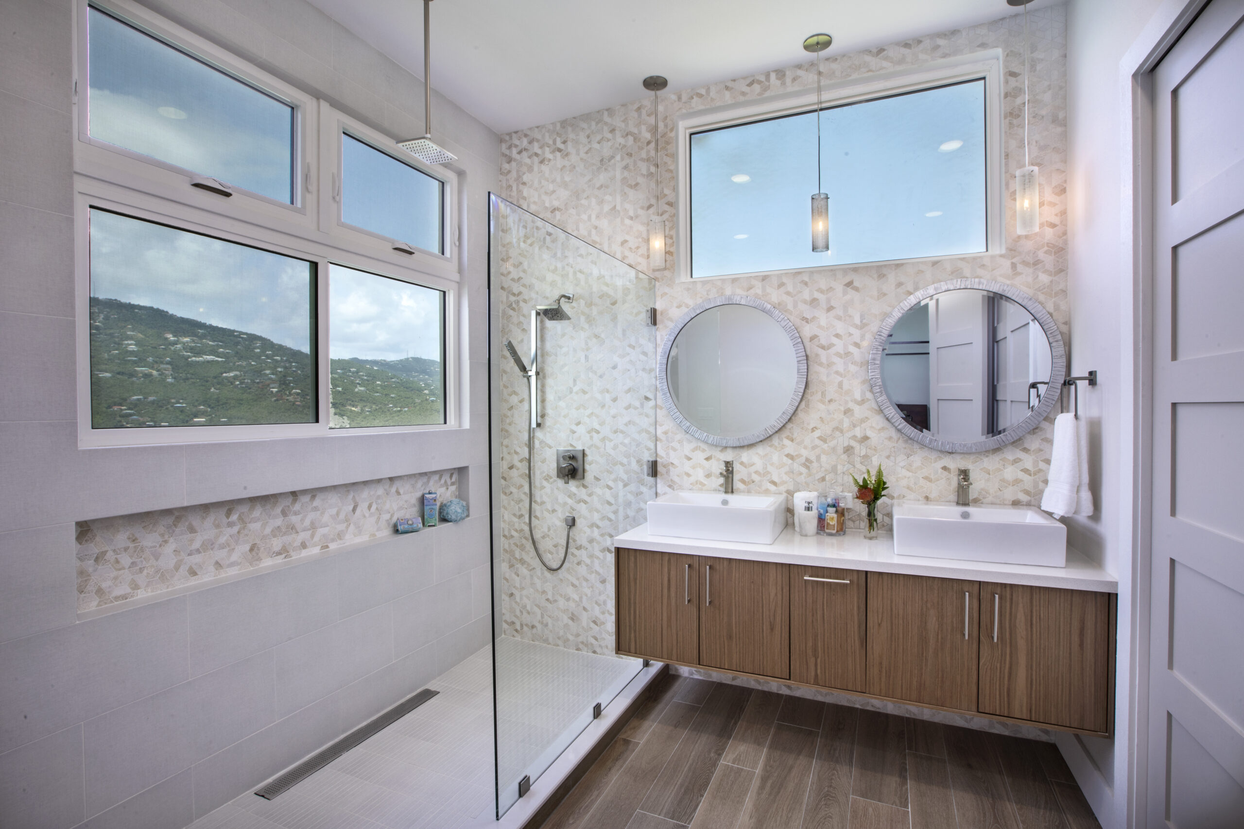 Double Vanity Bath with Waterfall show head and floating cabinetry with gorgeous views