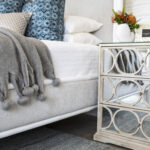 A cozy bedside with a custom nightstand and decor