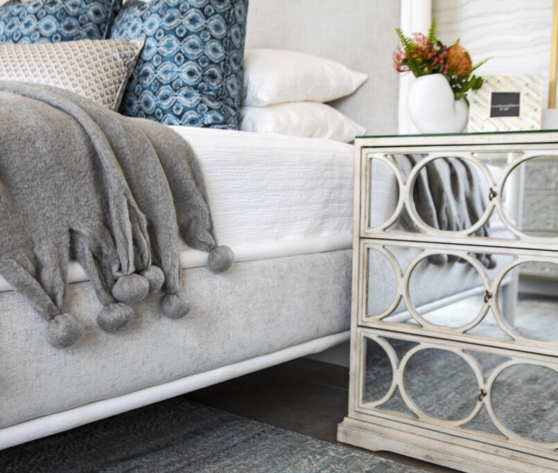 A cozy bedside with a custom nightstand and decor