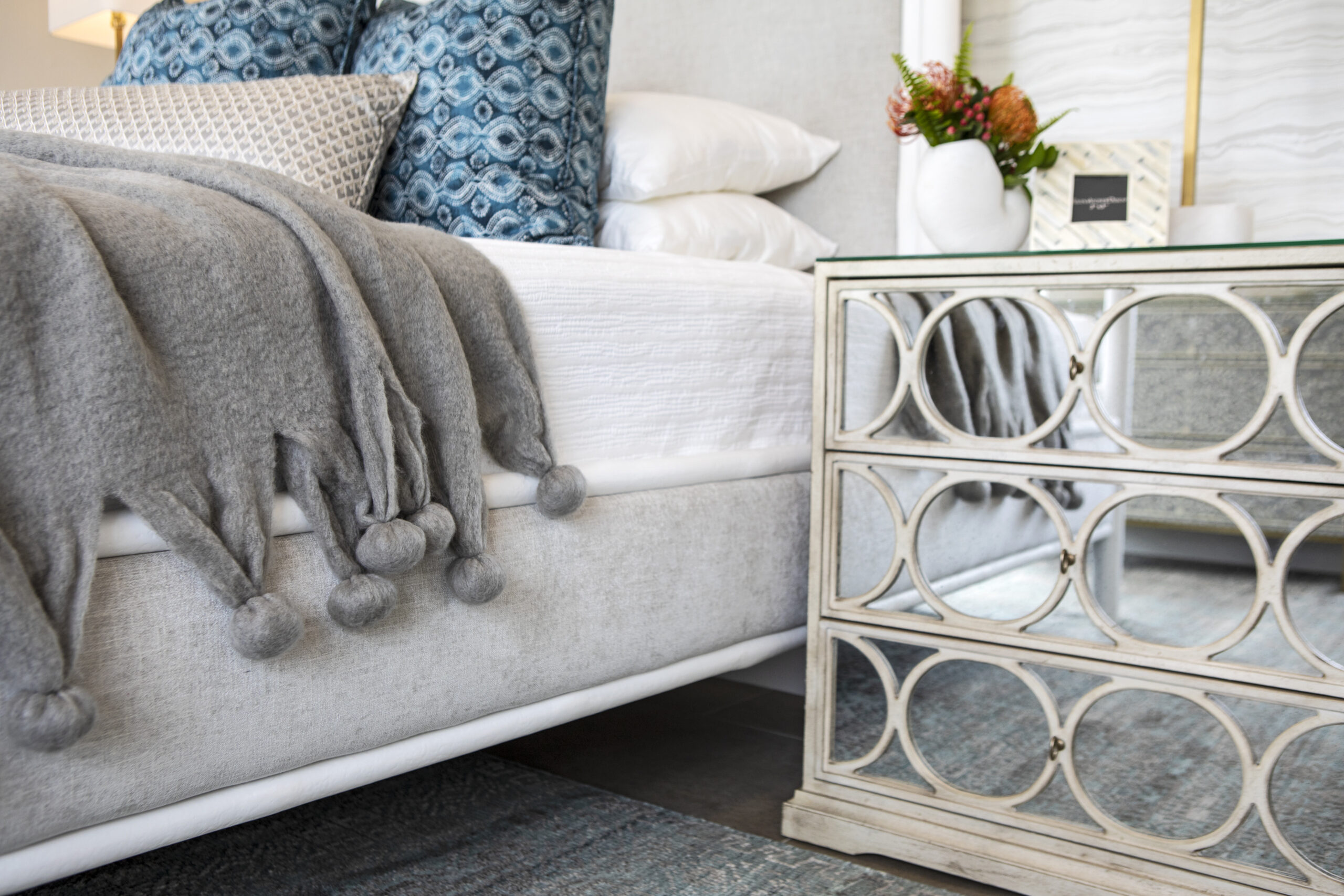 A cozy bedside with a custom nightstand and decor