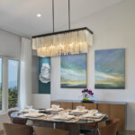dining room design with chandelier and landscape artwork