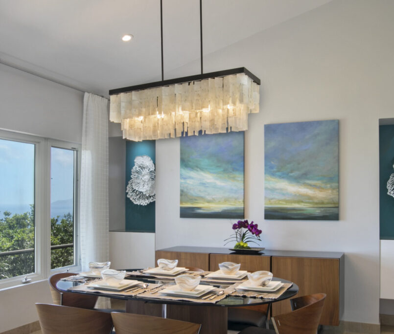 dining room design with chandelier and landscape artwork