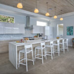 Light and Bright Kitchen Design with Overhead Lighting and Stools for Entertaining