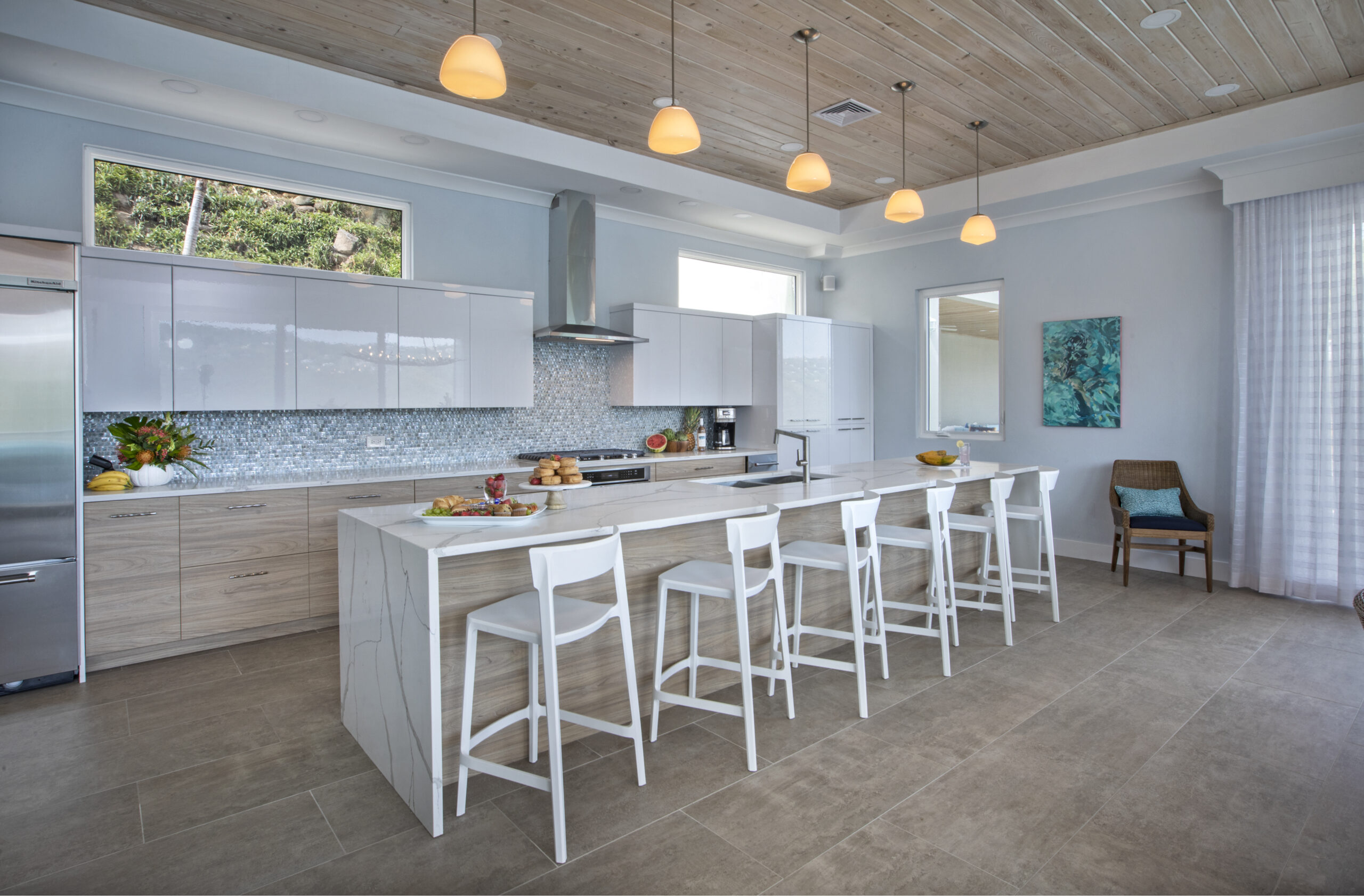 Light and Bright Kitchen Design with Overhead Lighting and Stools for Entertaining