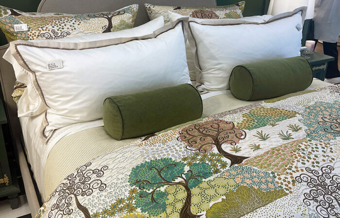 headboard with monogram embroidered. Tree motif quilt. at high point 2026