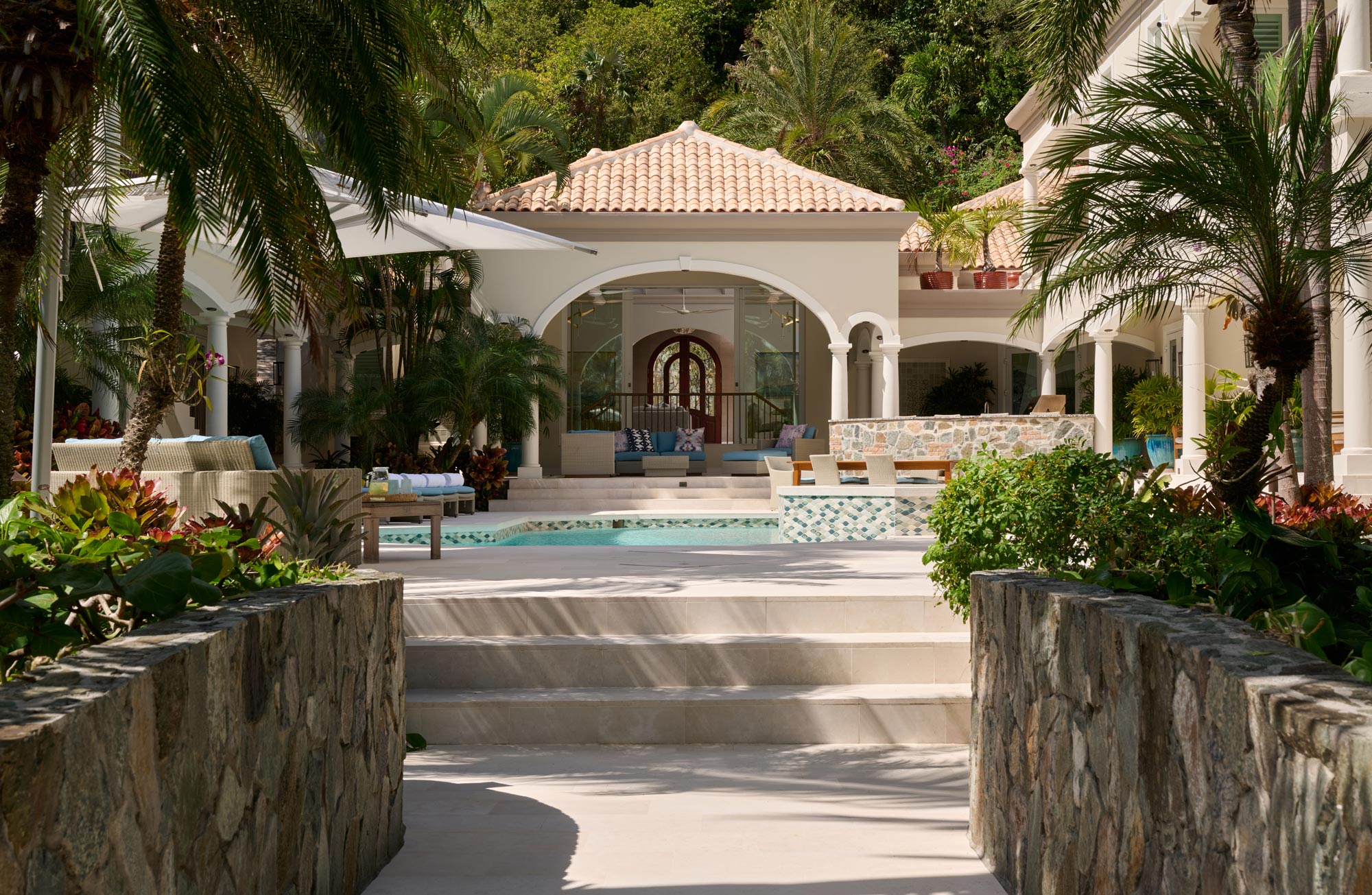 Peter Bay home remodel exterior pool and covered outdoor patio spaces relaxing island design style